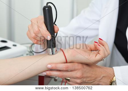 Dermatologist examining birthmarks and moles on a female patient (examination of birthmarks)