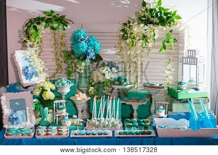 Candy bar on wedding ceremony with a lot of different candies and beverages.