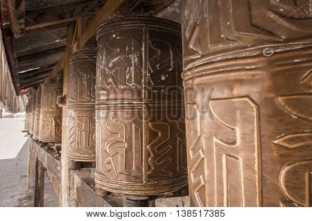 Kora Prayer wheels installed in Tibetan temple.