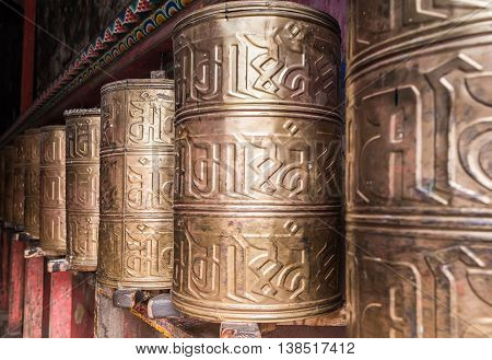 Kora Prayer wheels installed in Tibetan temple.