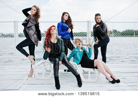 Five Beautiful Young Girls Models At Leather Jackets Posing On Berth.