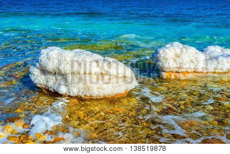 The scenic nature of the Dead Sea with unusual stones covered the crystals of salt Ein Gedi Israel.