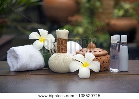 Spa massage compress balls, herbal ball on the wooden with treaments spa , Thailand, soft focus