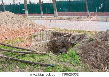 Dug Pit Fenced For Replacing Electric Cables Underground