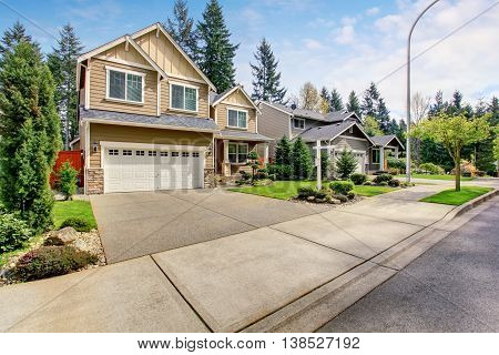 Nice Curb Appeal Of American Two Story House With Perfect Landscape Design.