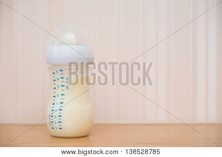 baby bottle of powdered milk at home with copy space