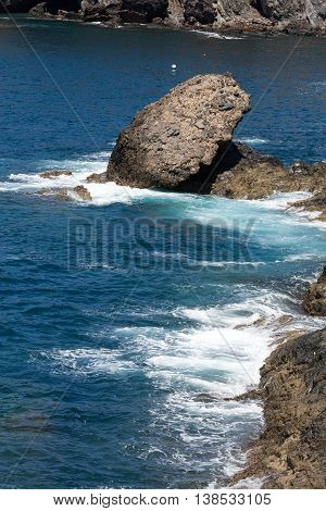 Wave splashing over a rock on Caleta Negra beach in Ajuy on Fuerteventura. Canary Island Spain