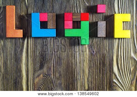 The word on the logic of multicoloured wooden blocks on a wooden background