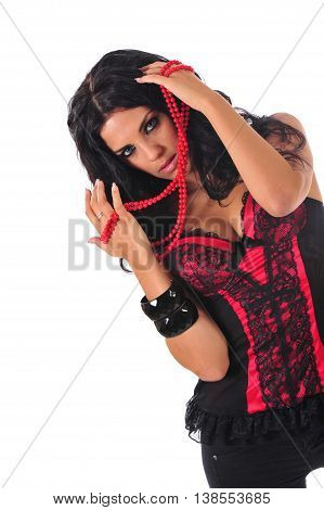 Sexy brunette in red corset holding red beads