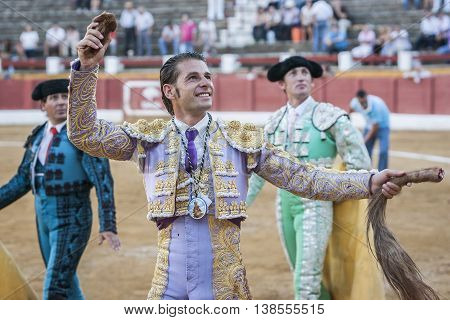Andujar SPAIN - September 10 2011: The Spanish Bullfighter David Valiente to the turning of honour with an ear in his hand Andujar Spain