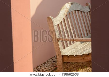 Wooden bench in mediterran garden house outside