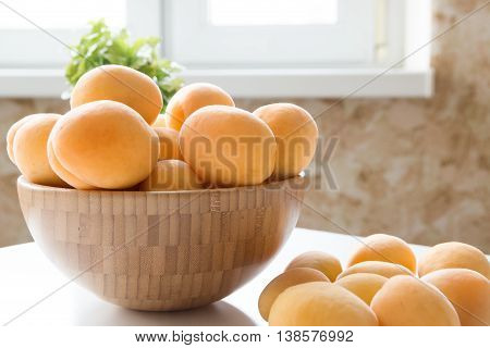 Apricots. Group of fresh fruits in a wooden bowl