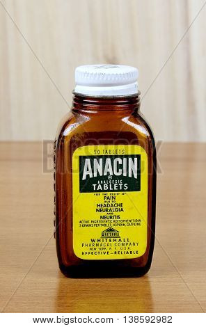 RIVER FALLS,WISCONSIN-JULY 15,2016: A vintage Anacin bottle with wood background. Anacin is a product of Whitehall Pharmacal Company.