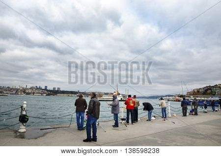 Istanbul Turkey - December 4 2013: Bosphorus Fishing Istanbul. Istanbul Asian side of the photo seen people fishing in the Uskudar district. In Istanbul particularly the differences in temperature and salinity between the Black Sea and the Mediterranean m