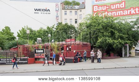 BERLIN GERMANY - JULY 14 2016: Train cocktail bar in Berlin-Schoeneberg with passers-by