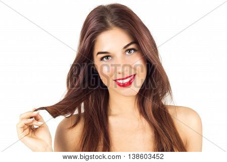 Sexy smiling tanned woman with red lips. Woman with make up. Tanned woman playing with her hair.
