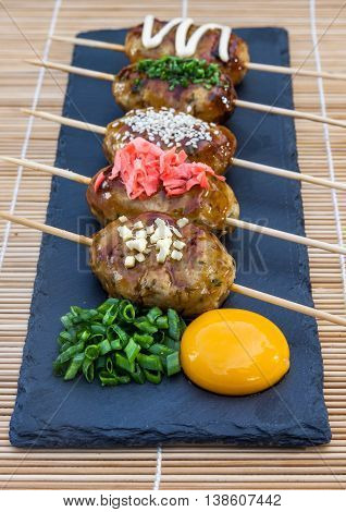 Tsukune Japanese chicken meatballs with scallimons and yolk