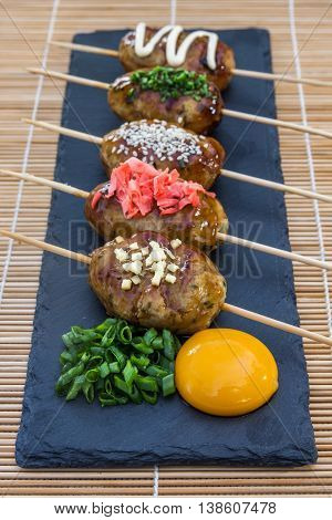 Tsukune Japanese chicken meatballs with scallimons and yolk