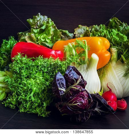 Close up of various colorful raw vegetables. Different raw vegetables background on dark wooden background. Healthy eating. Colorful vegetables background. Healthy food background.