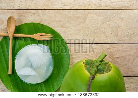coconut jelly and wooden spoon on wooden background