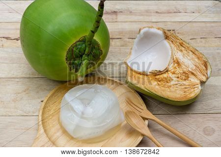 coconut jelly and wooden spoon on wooden background