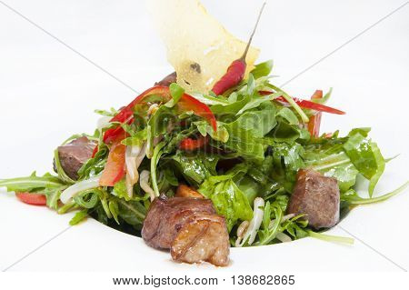 duck with arugula on a white background in the restaurant