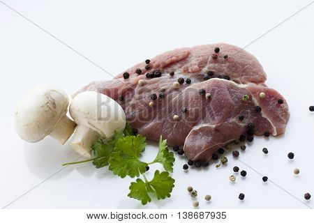 a piece of meat, white background, parsley, tomatoes and mushrooms