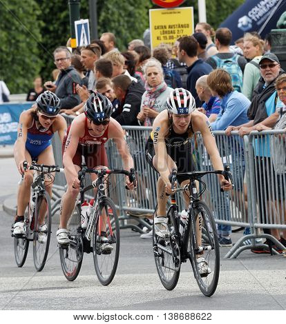 STOCKHOLM - JUL 02 2016: Group of female triathlete cyclists and audience in the Women's ITU World Triathlon series event July 02 2016 in Stockholm Sweden