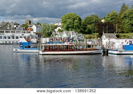 BOWNESS ON WINDERMERE, UK - JUNE 20, 2016: Pleasure cruise boats at the pier, Bowness on Windermere, Cumbria, UK