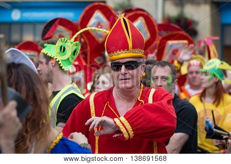 BATH SOMERSET UK - JULY 16 2016
Man dressed as cardinal. Bath Carnival procession around the streets of the city of Bath bringing a South American festival atmosphere to Somerset
