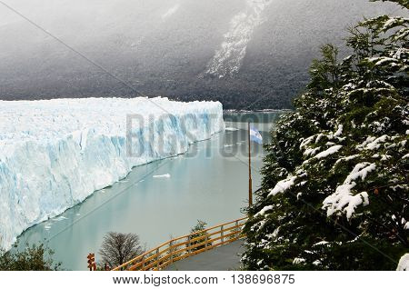 Perito Moreno glacier and Argentina flag, Patagonia