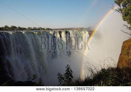 Powerful Victoria falls with rainbow, seen from Zimbabwe side