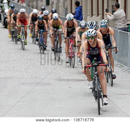 STOCKHOLM - JUL 02 2016: Group of female triathlete cyclists cycling downhill on cobblestone in the Women's ITU World Triathlon series event July 02 2016 in Stockholm Sweden