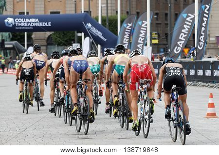 STOCKHOLM - JUL 02 2016: Rear view of large group of triathlete cyclists Zaferes Hewitt Ueda Vilic andcompetitors in the Women's ITU World Triathlon series event July 02 2016 in Stockholm Sweden