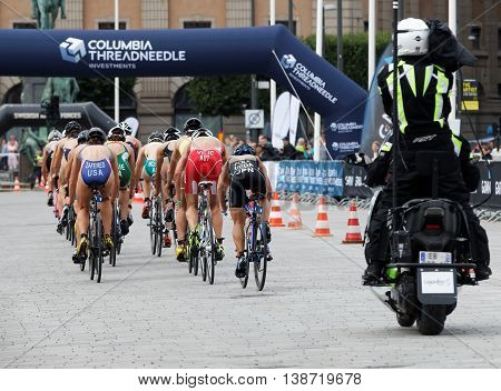 STOCKHOLM - JUL 02 2016: Rear view of large group of triathlete cyclists Zaferes Ueda Vilic andcompetitors in the Women's ITU World Triathlon series event July 02 2016 in Stockholm Sweden