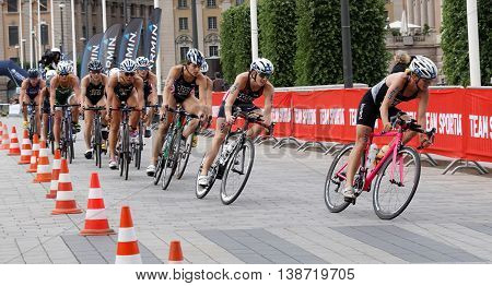 STOCKHOLM - JUL 02 2016: Large group of colorful female triathlete cyclists in a curve in the Women's ITU World Triathlon series event July 02 2016 in Stockholm Sweden