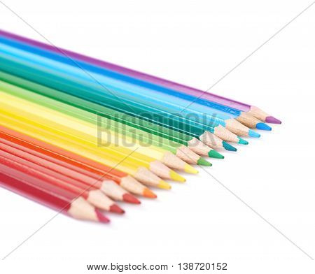 Multiple colorful color pencils composition arranged in a line to form a rainbow gradient, composition isolated over the white background