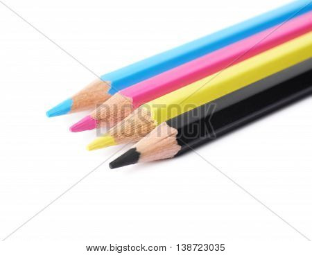 Four cmyk colored drawing pencils composition isolated over the white background, close-up crop