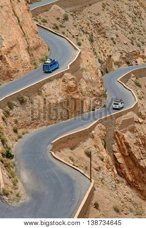 DADES GORGES, MOROCCO - JULY 11: Overloaded car on a winding road, July 11, 2013 in Dades Gorges, Morocco. Road in Dades Gorges very popular tourist route in east Morocco.