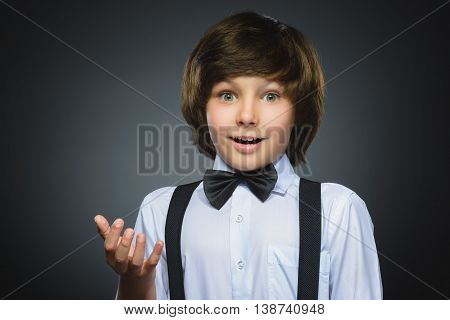 Closeup Portrait of happy boy going surprise isolated on gray background.