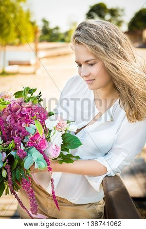 portrait of beautiful girl with flowers. Blonde