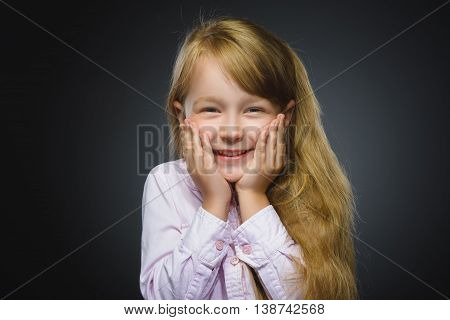 Closeup Portrait of happy girl going surprise isolated on gray background.