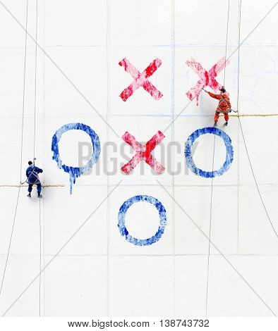 Maintenance workers  play tick-tack-toe  outside a wall 