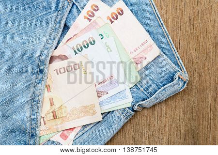 Close up of Thai baht banknotes in jeans pocket.