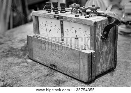 Vintage analog wooden electric meter on the old table test