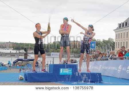 STOCKHOLM - JUL 02 2016: Flora Duffy Andrea Hewitt and Helen Jenkins laughing and squirting champagne on the winner's stand in the Women's ITU World Triathlon series event July 02 2016 in Stockholm Sweden