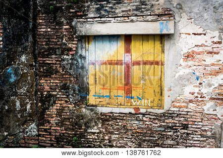 Old wood window on old cracked wall