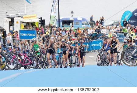 STOCKHOLM - JUL 02 2016: Group of triathletes running with cycles in the transition zone in the Women's ITU World Triathlon series event July 02 2016 in Stockholm Sweden