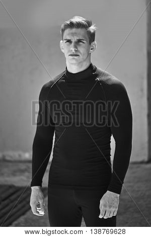 Black-and-white photos of athletic men in tight black clothes