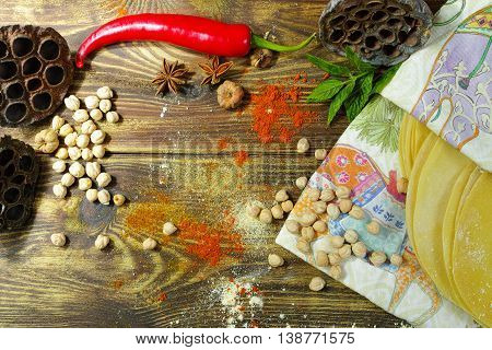 Colorful Indian food - papadum chickpea gram flour and spices on textured wooden table top